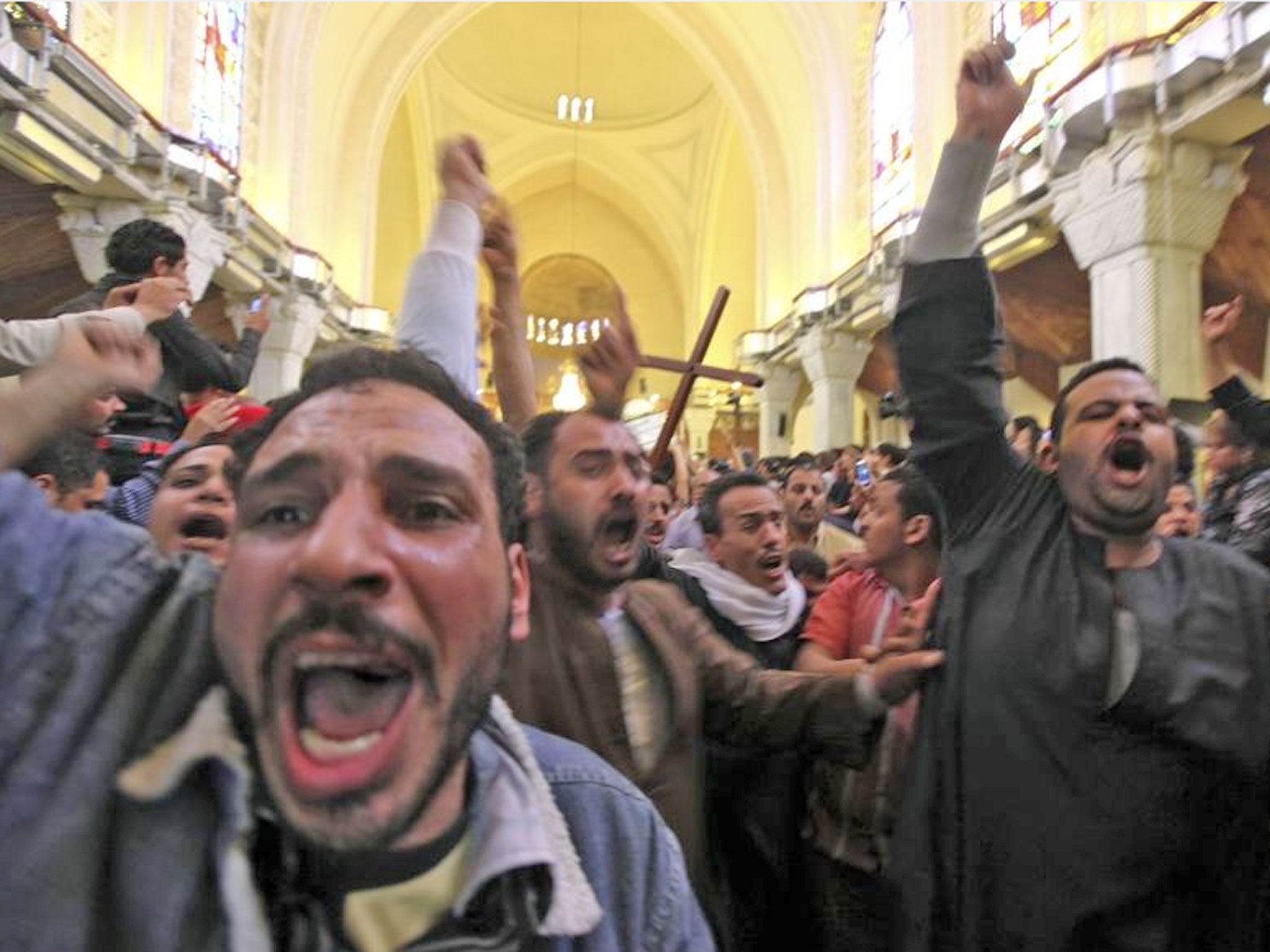 Mourners at St Mark’s Coptic cathedral in Cairo carry the coffin of one of the Egyptian Christians killed in sectarian clashes on Saturday