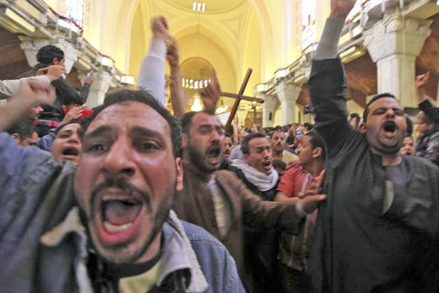 Mourners at St Mark’s Coptic cathedral in Cairo carry the coffin of one of the Egyptian Christians killed in sectarian clashes on Saturday