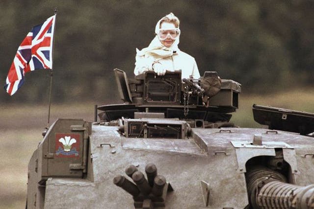 Margaret Thatcher stands in a British tank