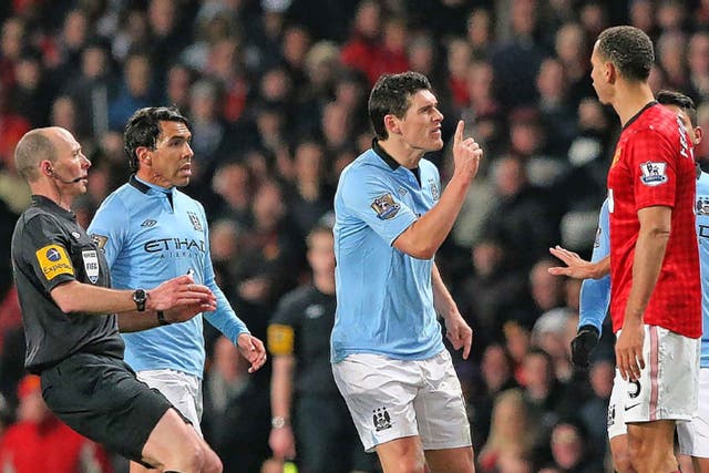 Gareth Barry and Rio Ferdinand square up to each other as tensions rise