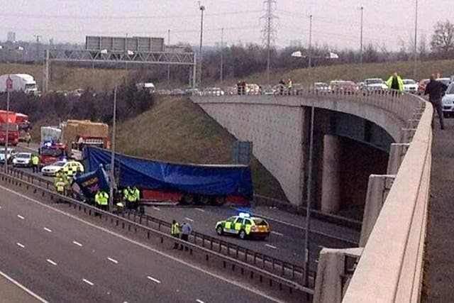 The scene after a HGV driver had a lucky escape after his lorry left the flyover on the M42 and crashed onto the M6 toll near Coleshill in Warwickshire