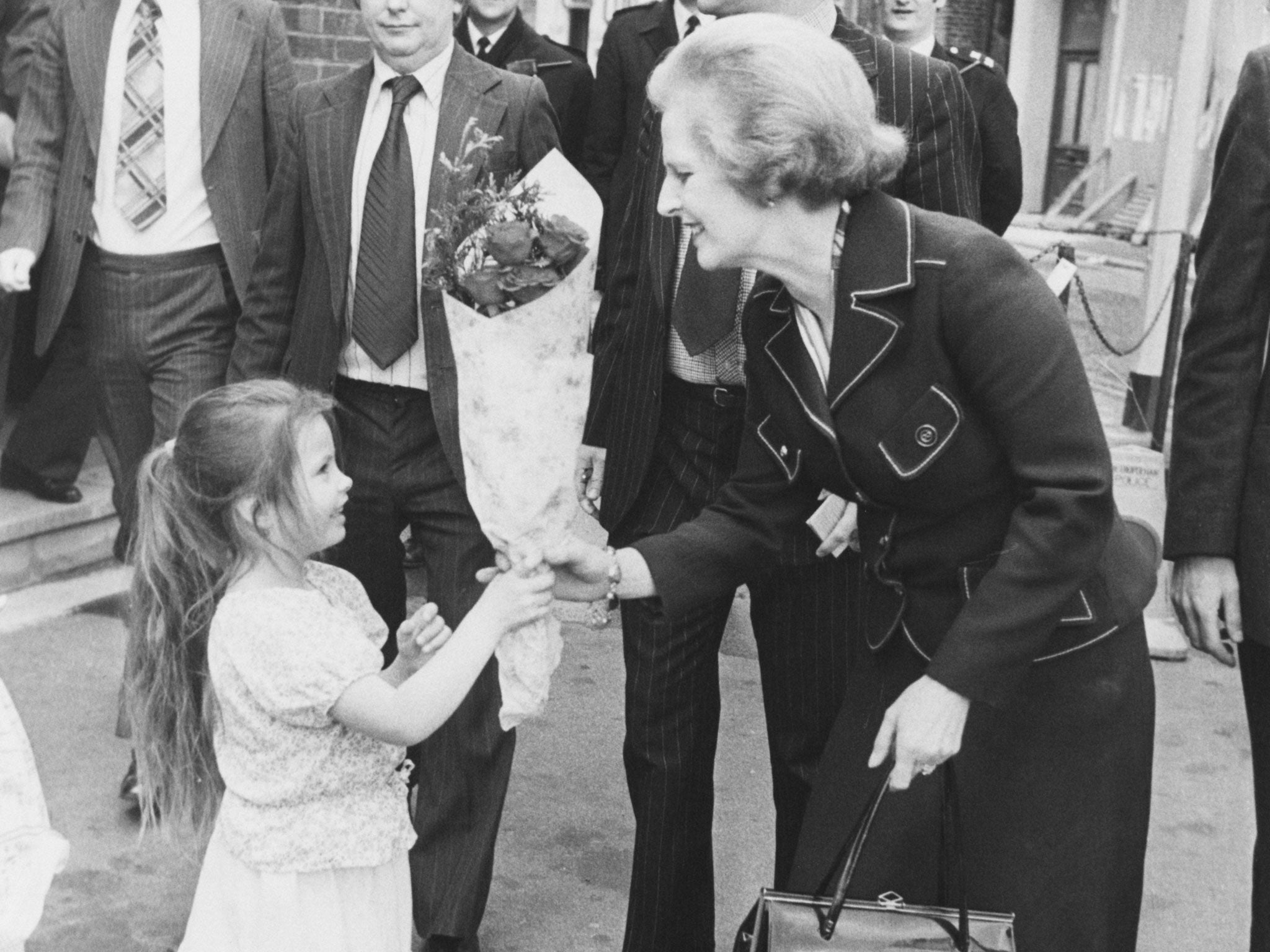 Margaret Thatcher, Leader of the Conservative Party, receives a bouquet of flowers from 4-year-old Nancy Turner, as she leaves the Greenwood Theatre on Weston Street, London, 30th April 1979.