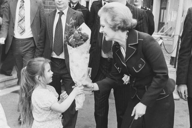 Margaret Thatcher, Leader of the Conservative Party, receives a bouquet of flowers from 4-year-old Nancy Turner, as she leaves the Greenwood Theatre on Weston Street, London, 30th April 1979.