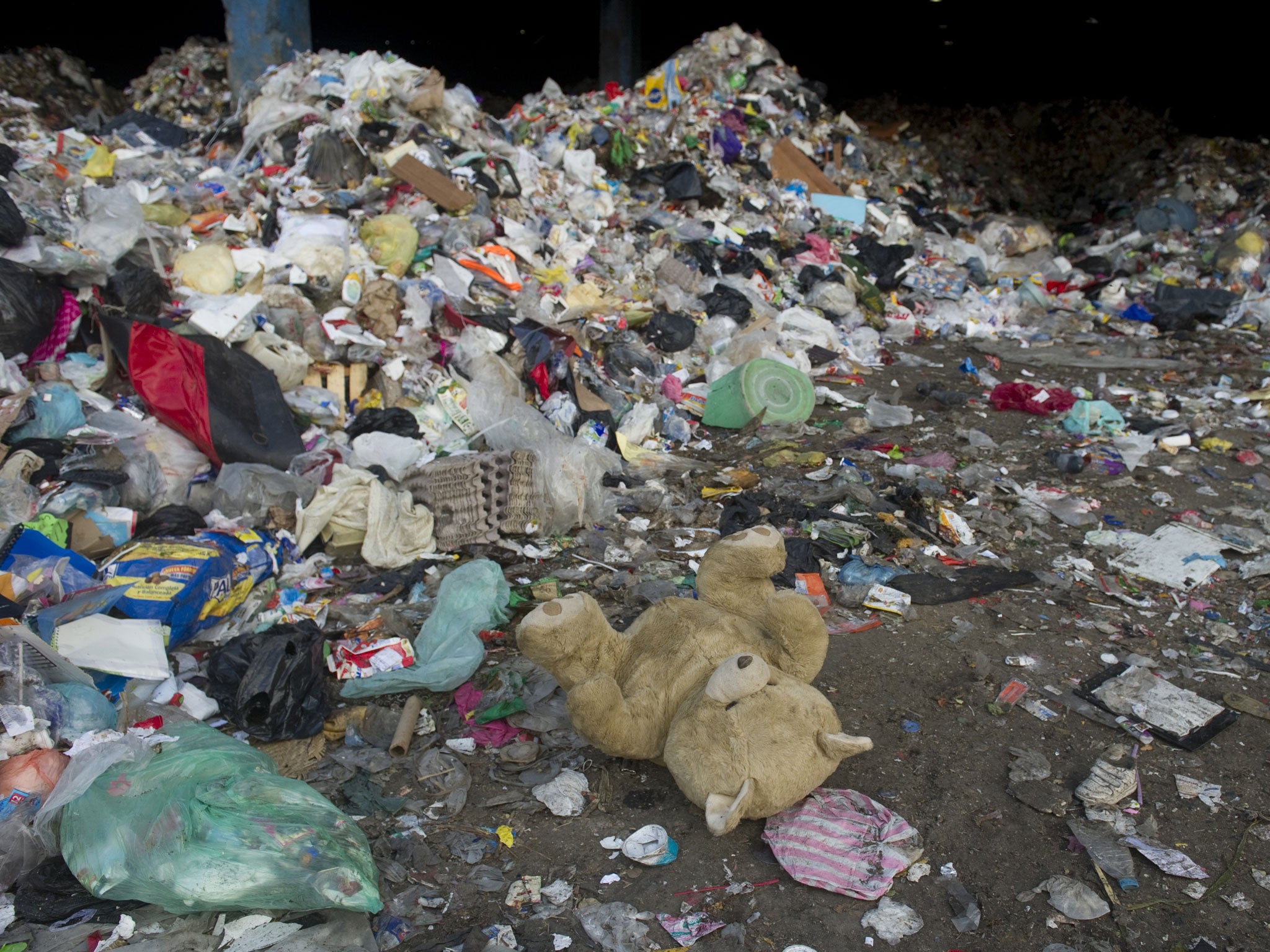 An abandoned teddy bear lies amid the refuse at the 'Bordo Poniente' garbage dump in Mexico City, on January 18, 2012.