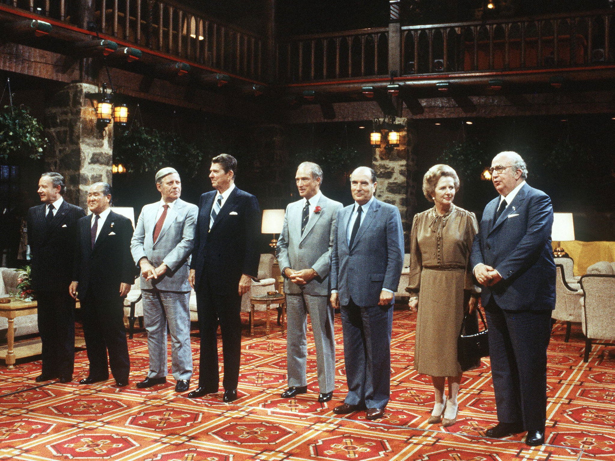 U.S. President Ronald Reagan (c) surrounded by (l-r) President of the European Union commission Gaston Thorn, Japanese Premier Zenko Suzuki, German Chancellor Helmut Schmidt, Canadian Prime Minister Pierre Elliott Trudeau, French President Frantois Mitterrand, British Premier Margareth Thatcher and Italian Prime Minister Giovanni Spadolini during the Summit of the leading industrial countries, in Ottawa, 18 July 1981.