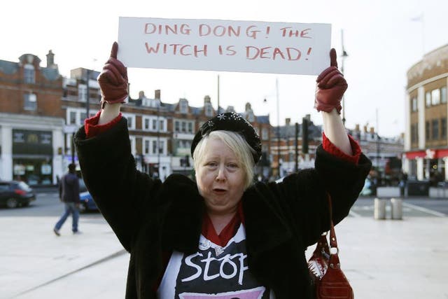 A reveller holds a sign to celebrate the death of Britain's former prime minister Margaret Thatcher