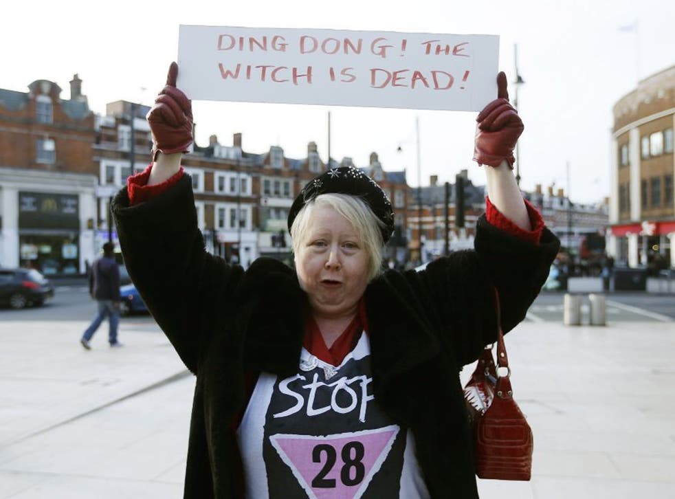 A reveller holds a sign to celebrate the death of Britain's former prime minister Margaret Thatcher