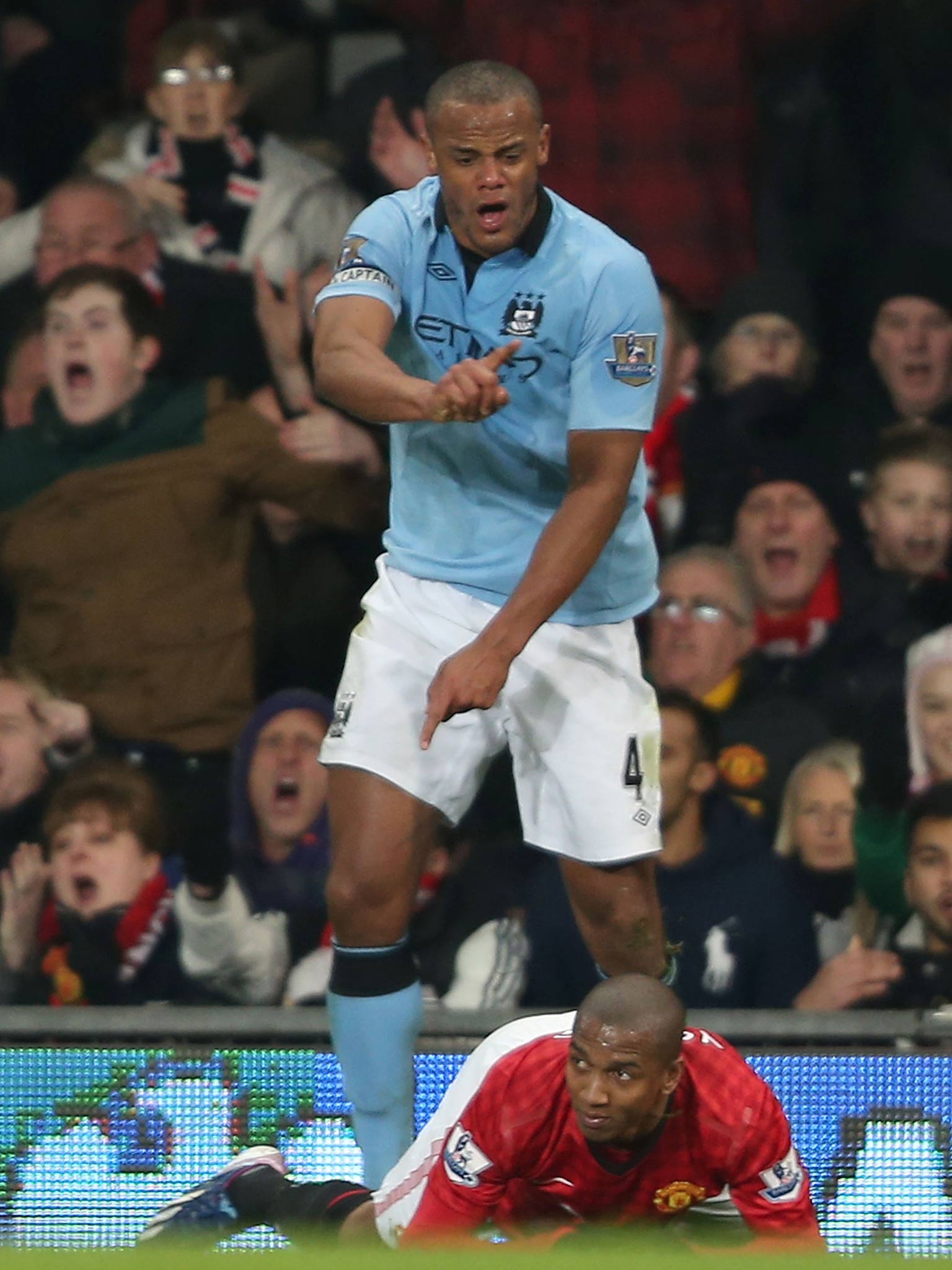 Vincent Kompany protests after fouling Ashley Young