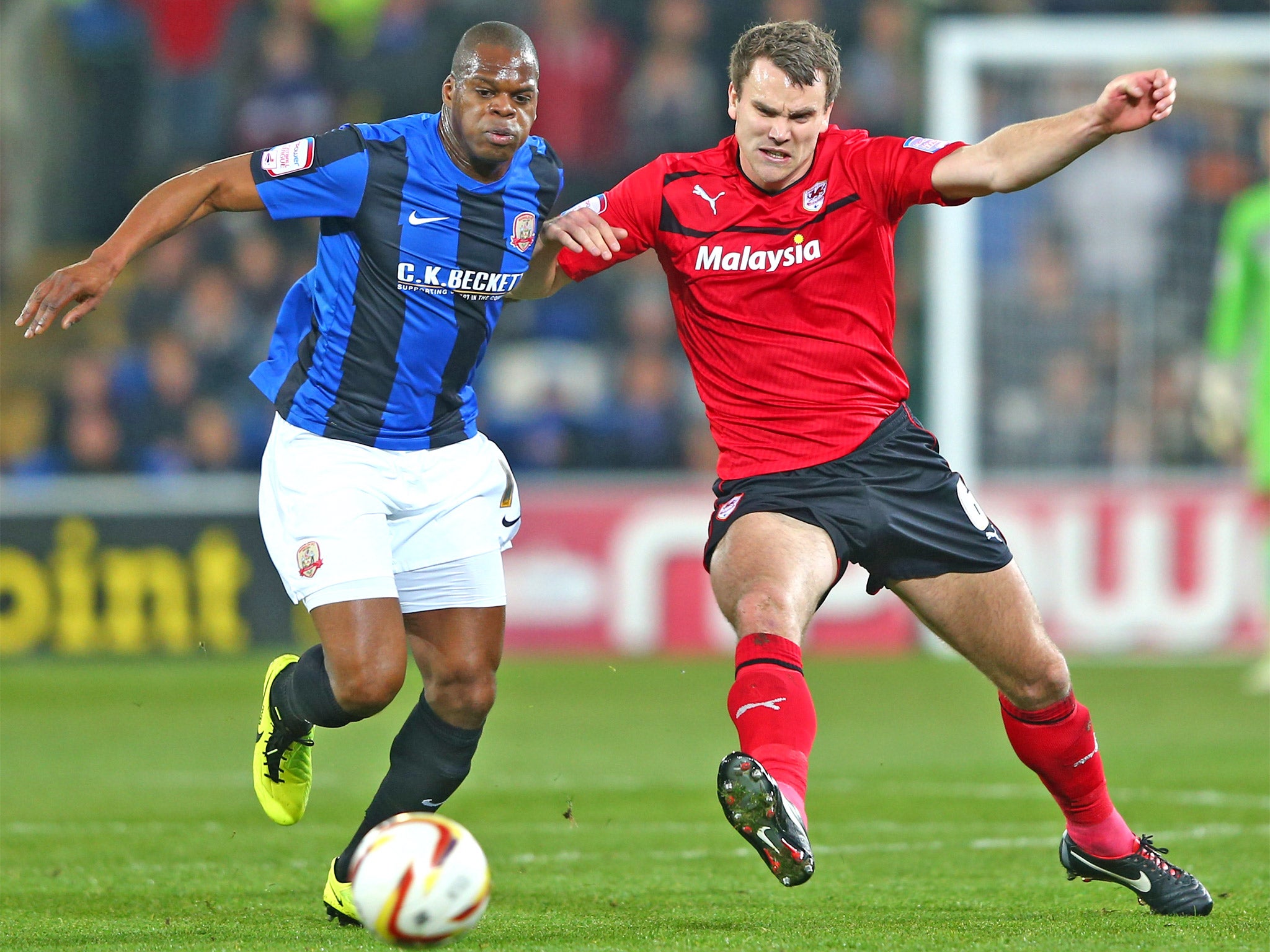Ben Turner (right), who scored Cardiff’s goal, challenges Marlon Harewood