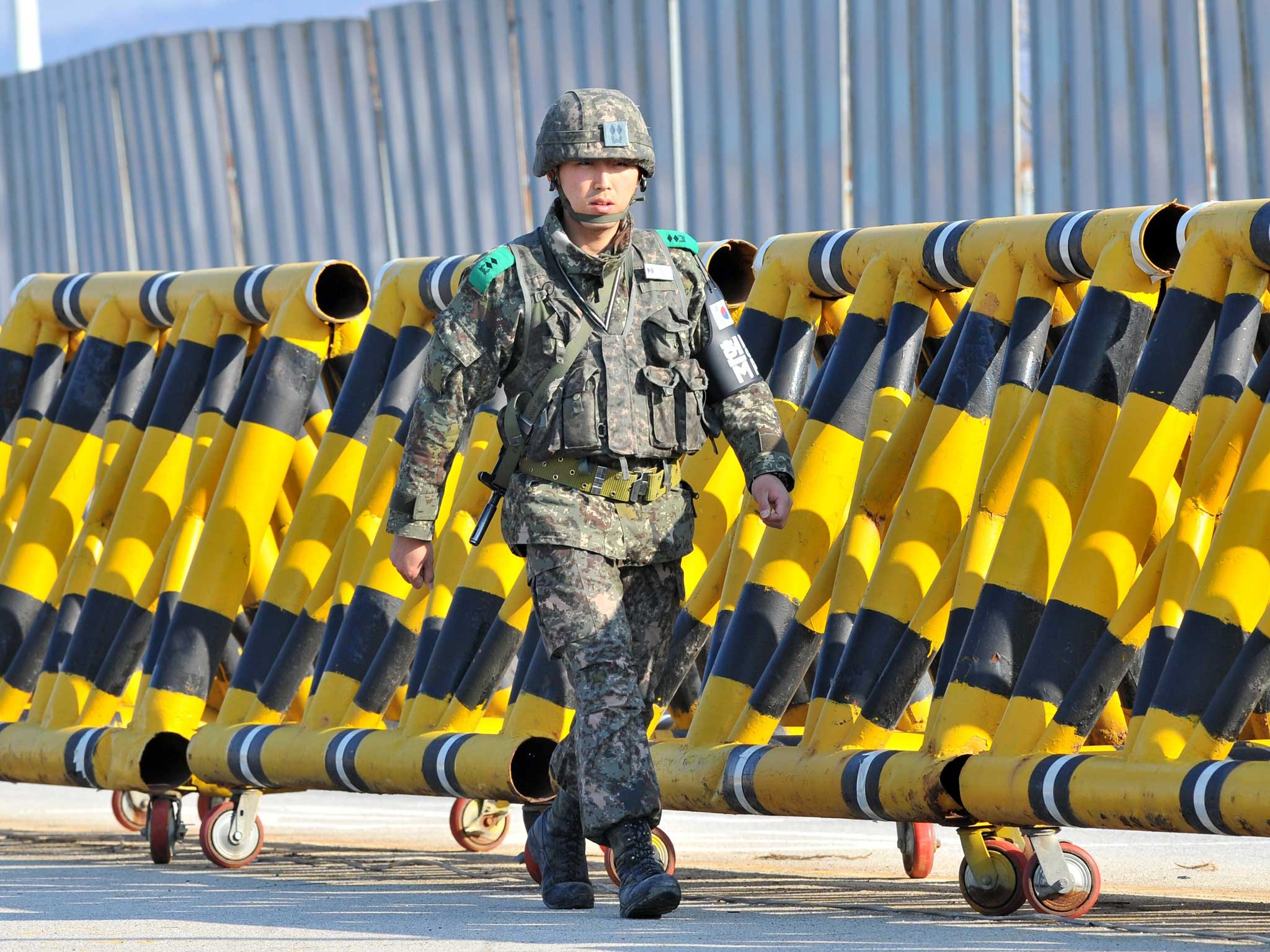 A South Korean soldier walks along barricades on the road leading to North Korea at a military checkpoint in the border city of Paju