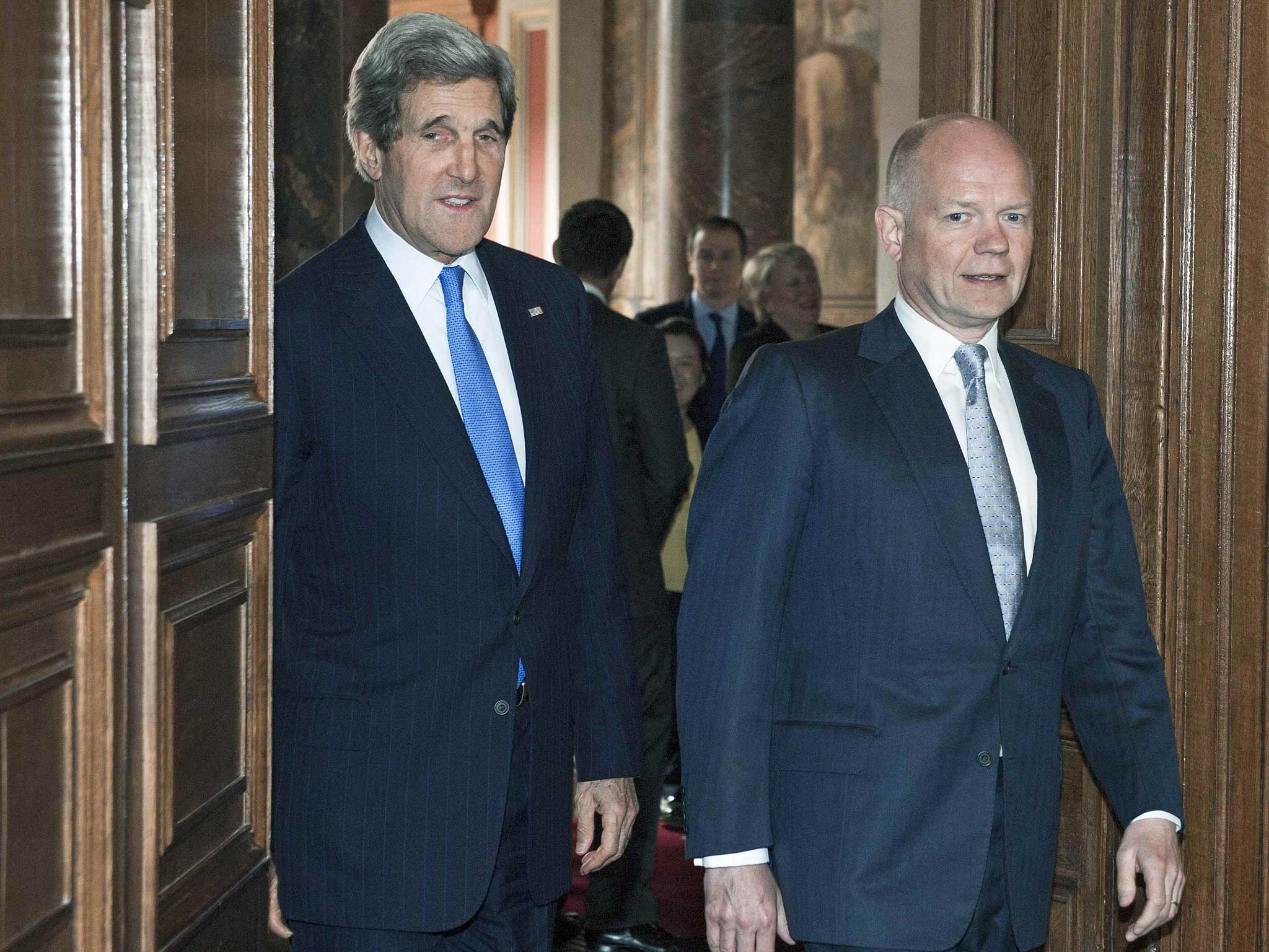 Foreign Secretary William Hague walks with US Secretary of State John Kerry