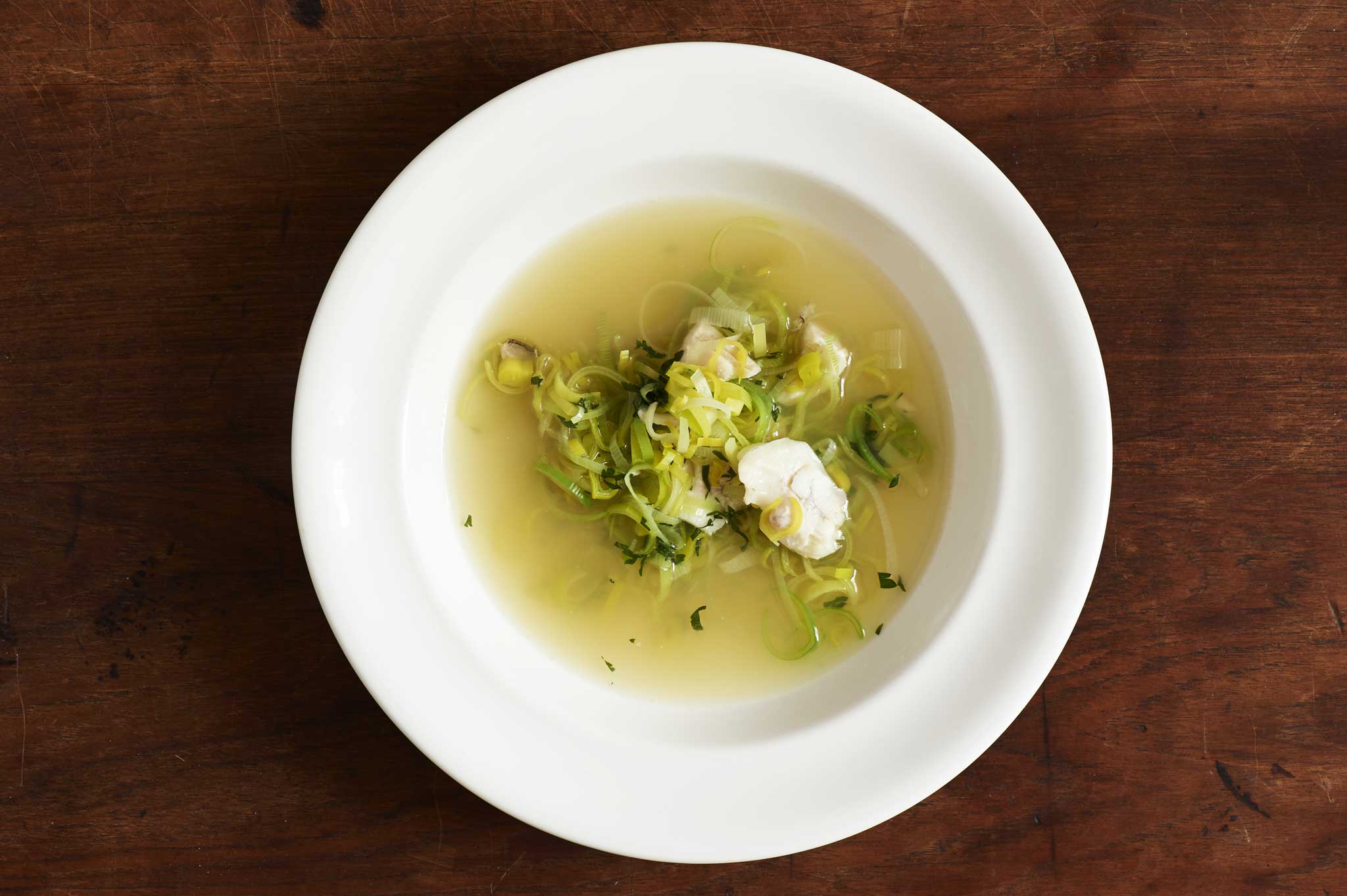 Turbot cheek and leek broth