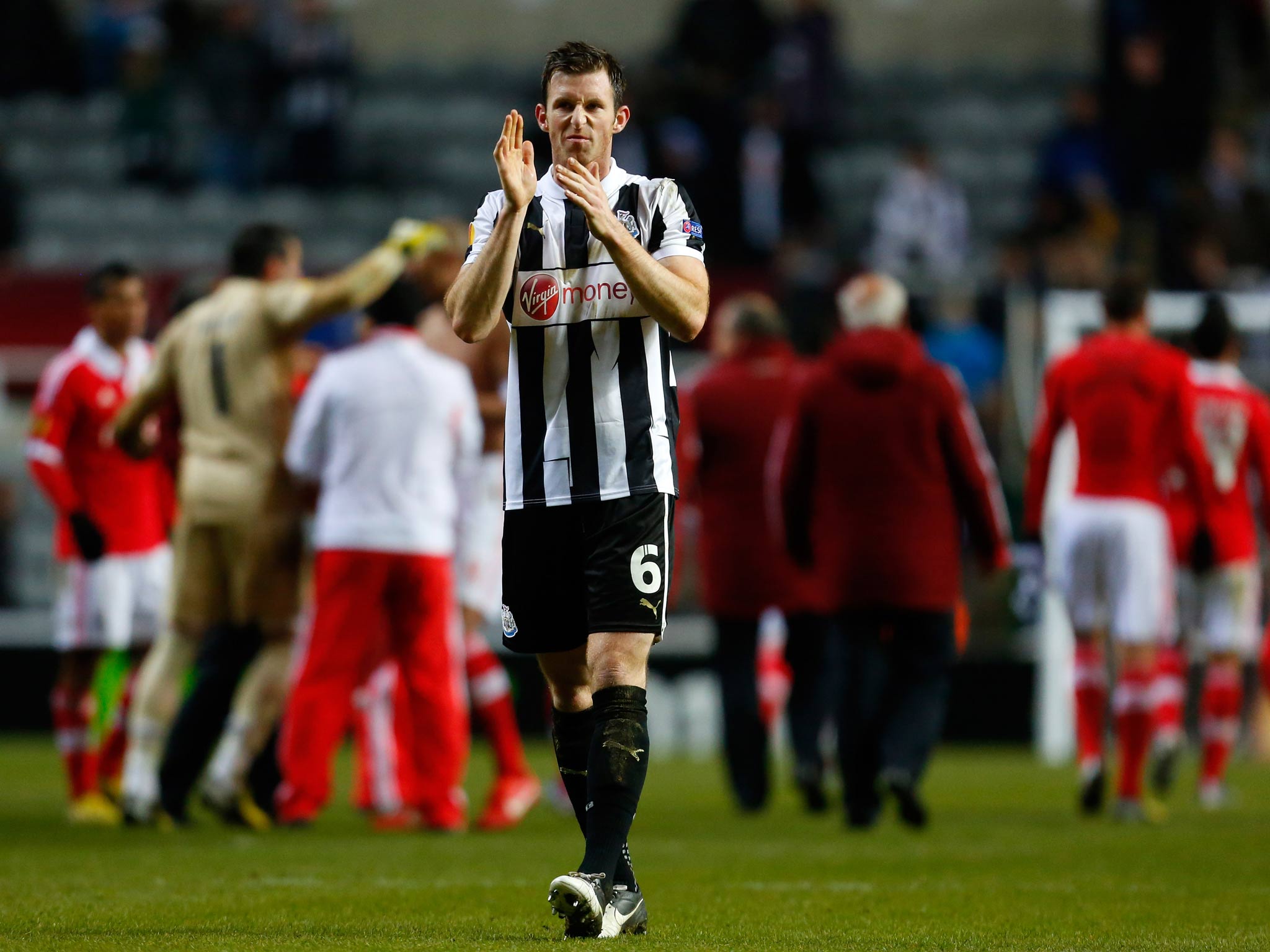 Mike Williamson of Newcastle applauds the home fans