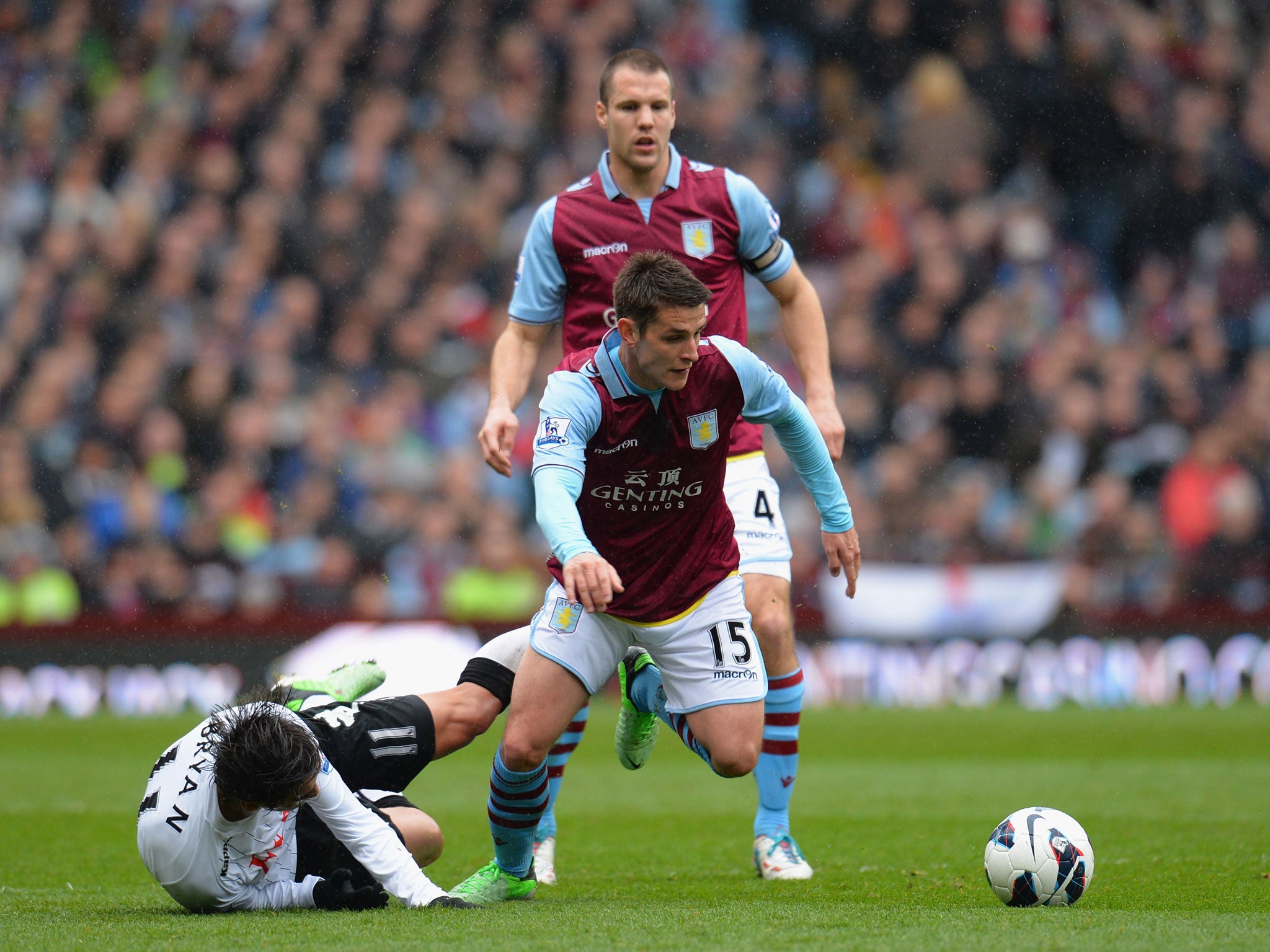 Ashley Westwood of Aston Villa breaks away from Bryan Ruiz of Fulham