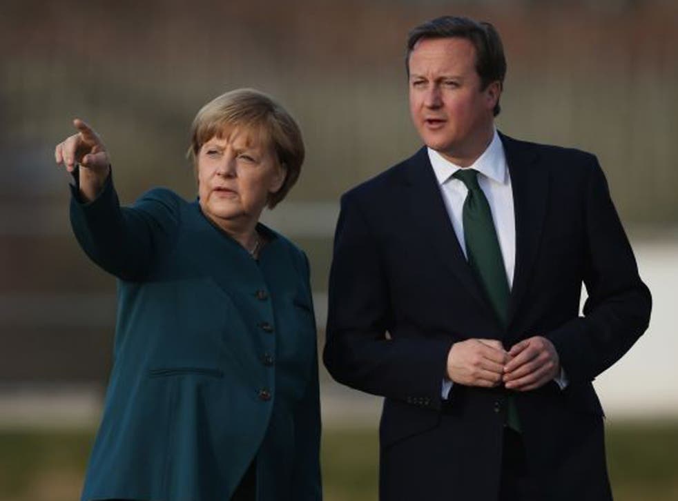 David Cameron speaks with Angela Merkel at the Meseberg government guest house yesterday