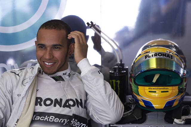 Smiles ahead: Lewis Hamilton is delighted after taking pole for Mercedes