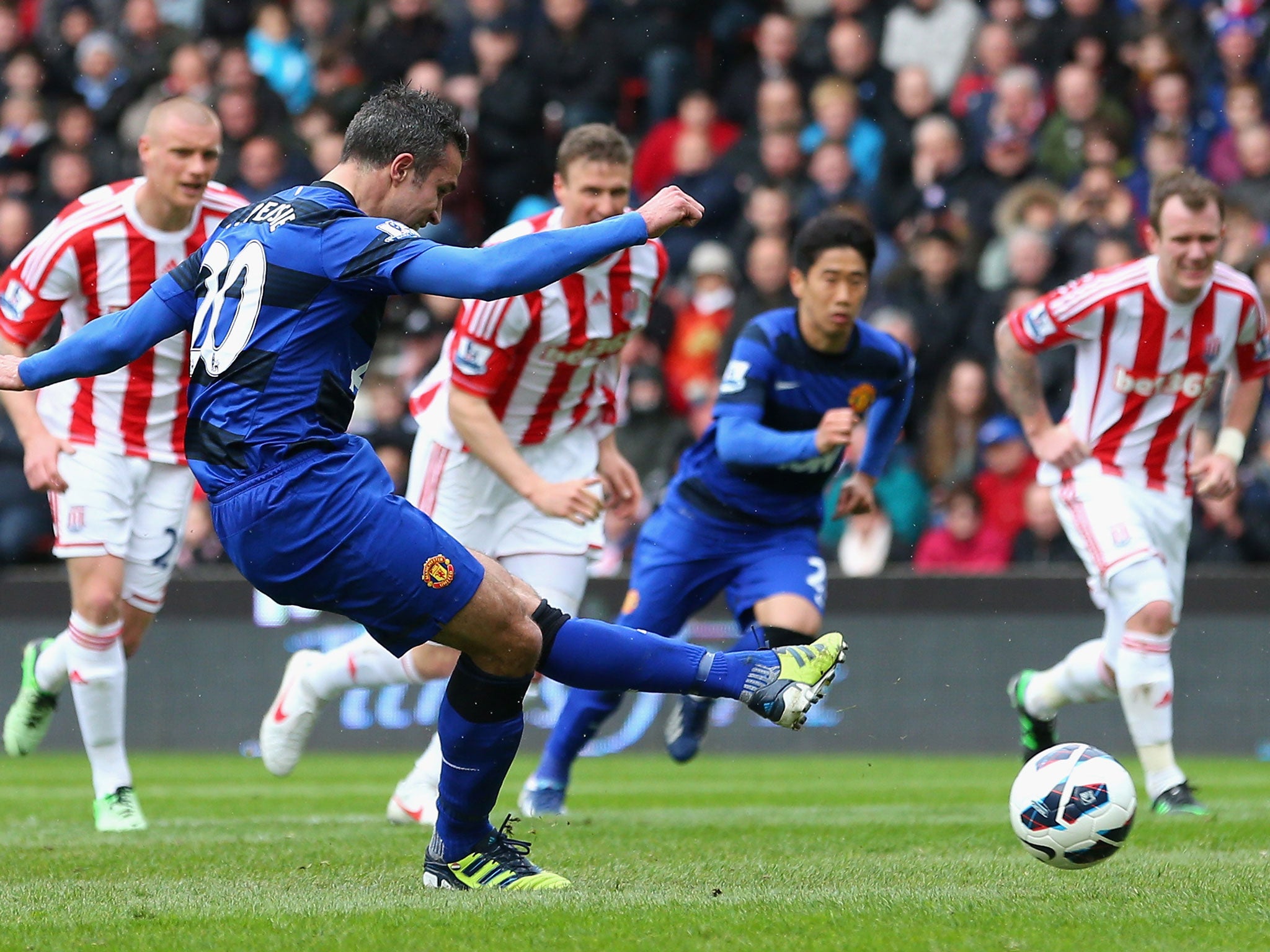 Robin van Persie of Manchester United scores from the penalty spot