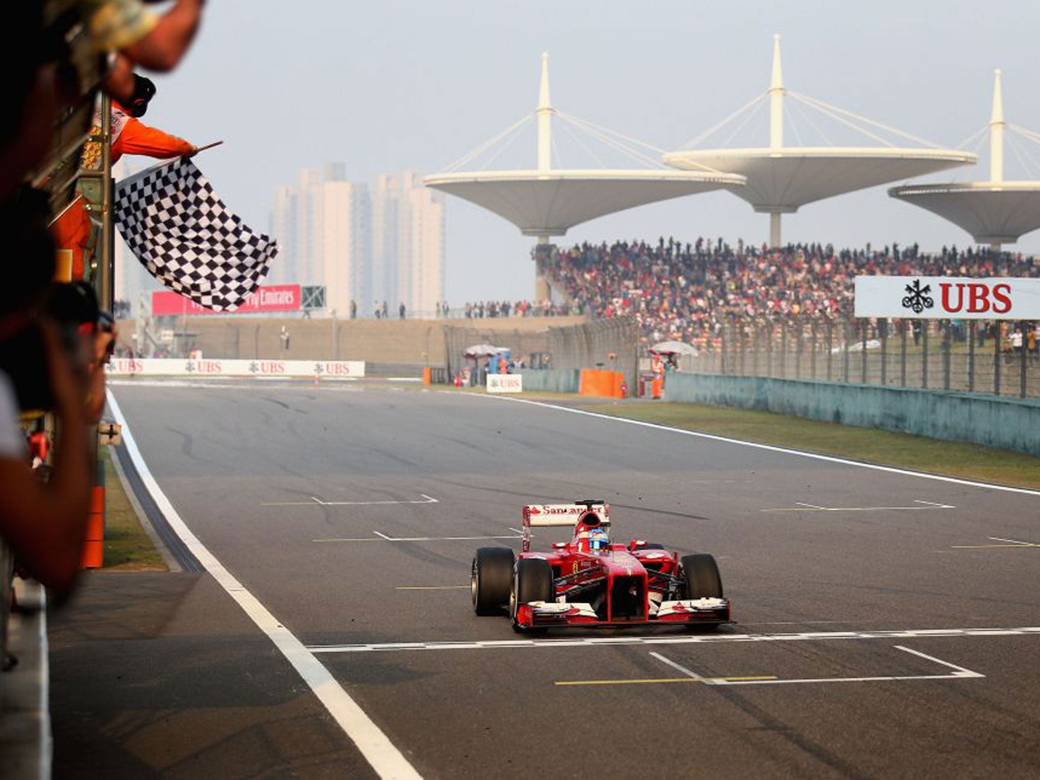 Ferrari’s Fernando Alonso takes the chequered flag in China