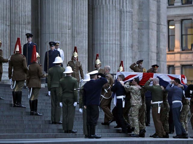 A Union flag-draped coffin is carried by members of the British armed forces into St Paul's Cathedral