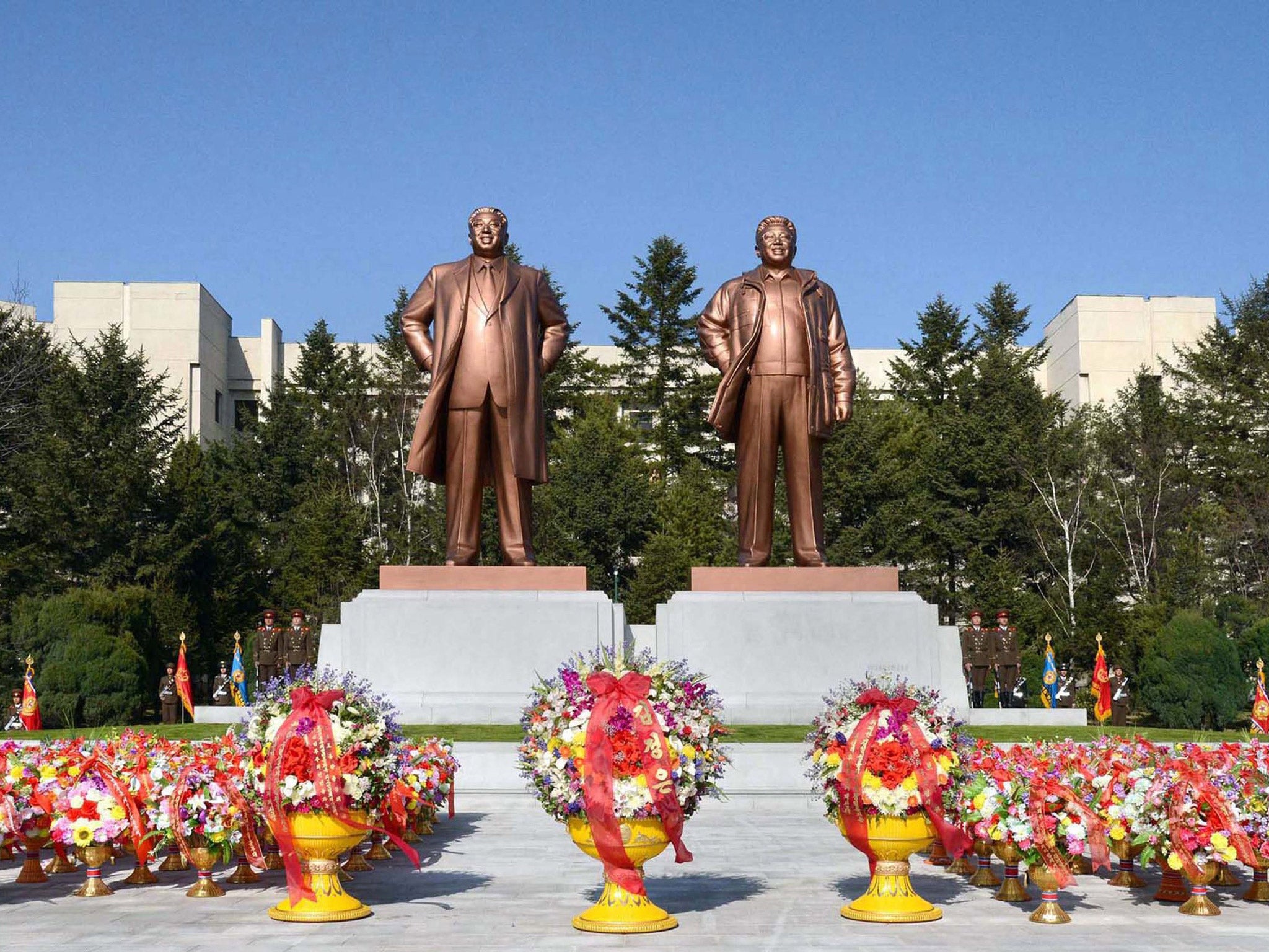 Bronze statues of late North Korean leaders Kim Il-Sung (L) and Kim Jong-il (R) being unveiled in Pyongyang ahead of the 101st anniversary of the birth of Kim Il-Sung