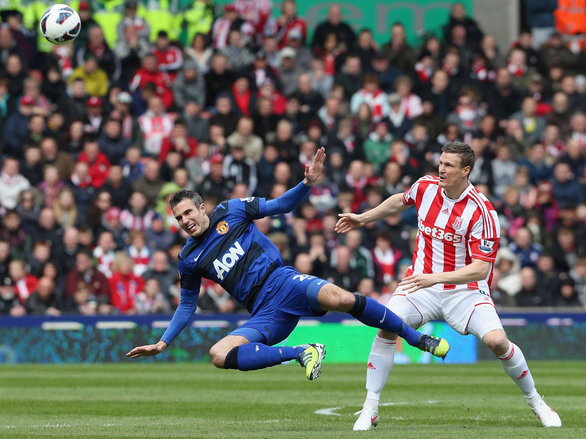 Robin van Persie of Manchester United in action with Robert Huth of Stoke City