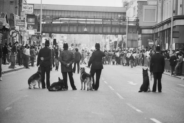 Police dog handlers on Atlantic Road on the second day of riots in Brixton, South London, 13th April 1981