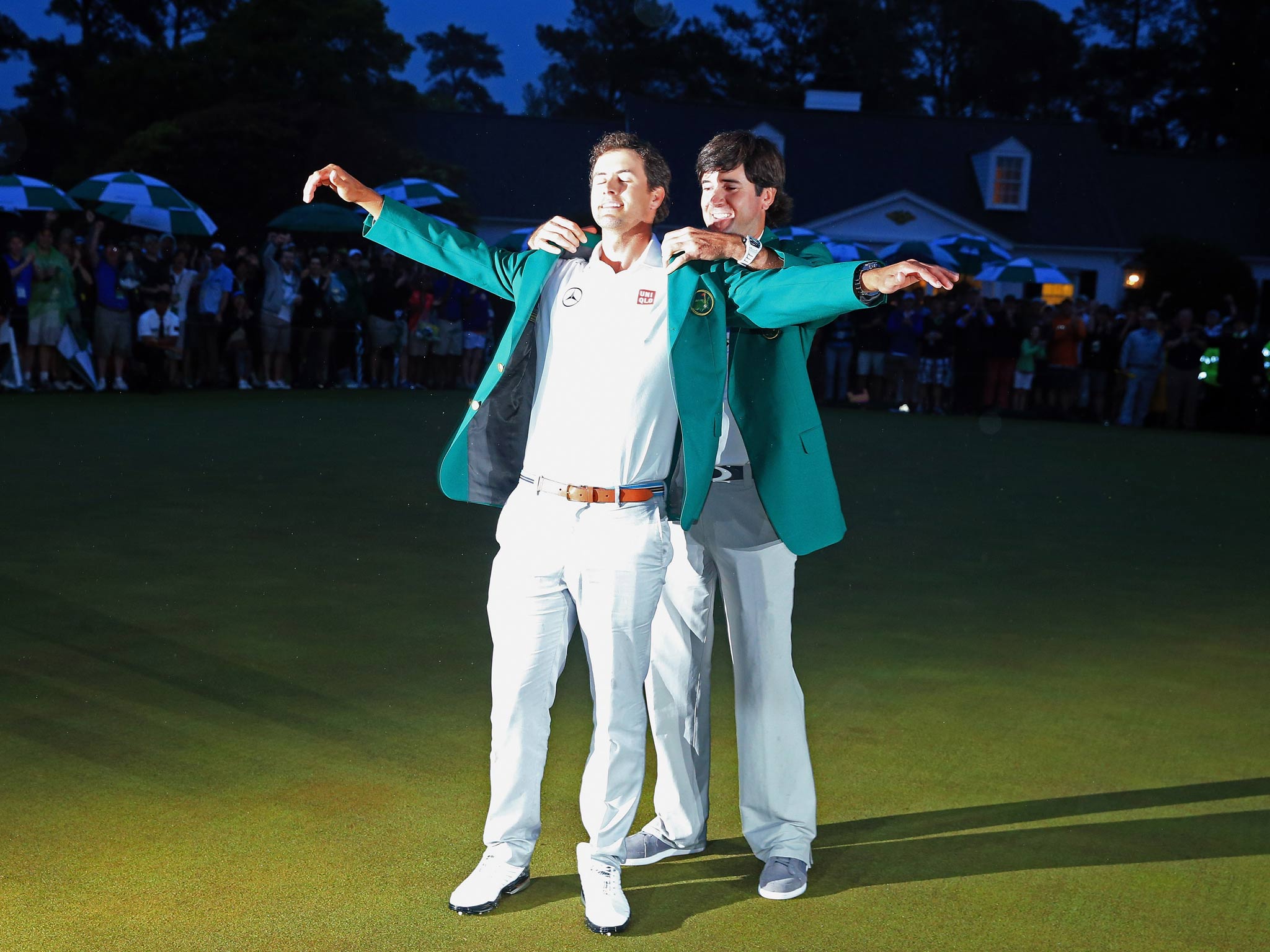 Adam Scott of Australia receives his green jacket from 2012 Masters champion Bubba Watson