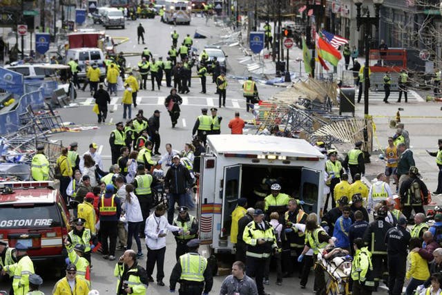 Medical workers aid injured people at the finish line of the 2013 Boston Marathon following an explosion in Boston, Monday, April 15, 2013.  