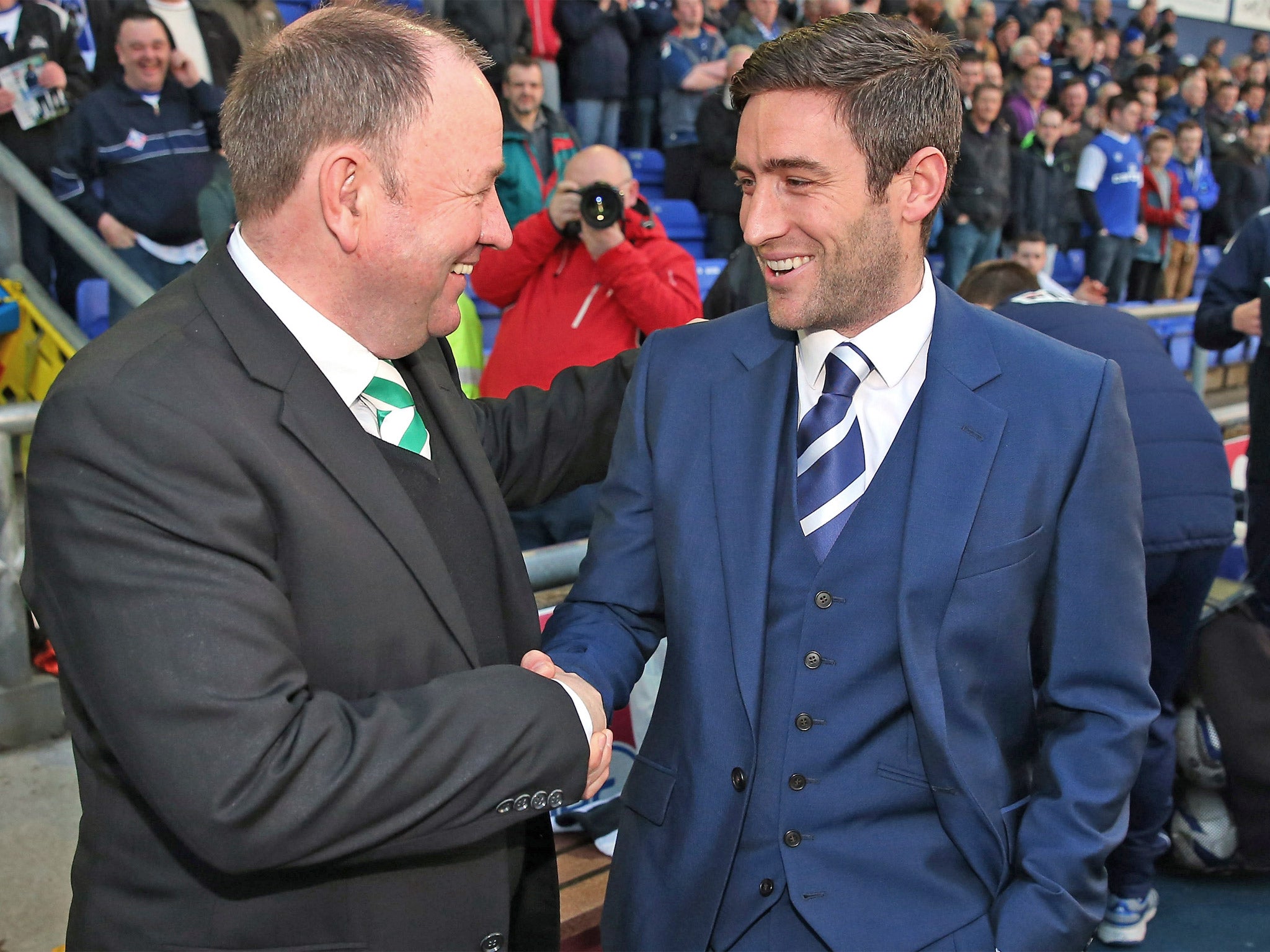 Oldham’s Lee Johnson (right) shakes hands with his dad, Gary