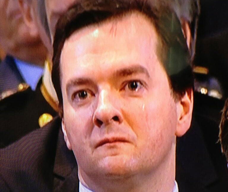 George Osborne appears to be crying and is seen wiping away a tear during the service