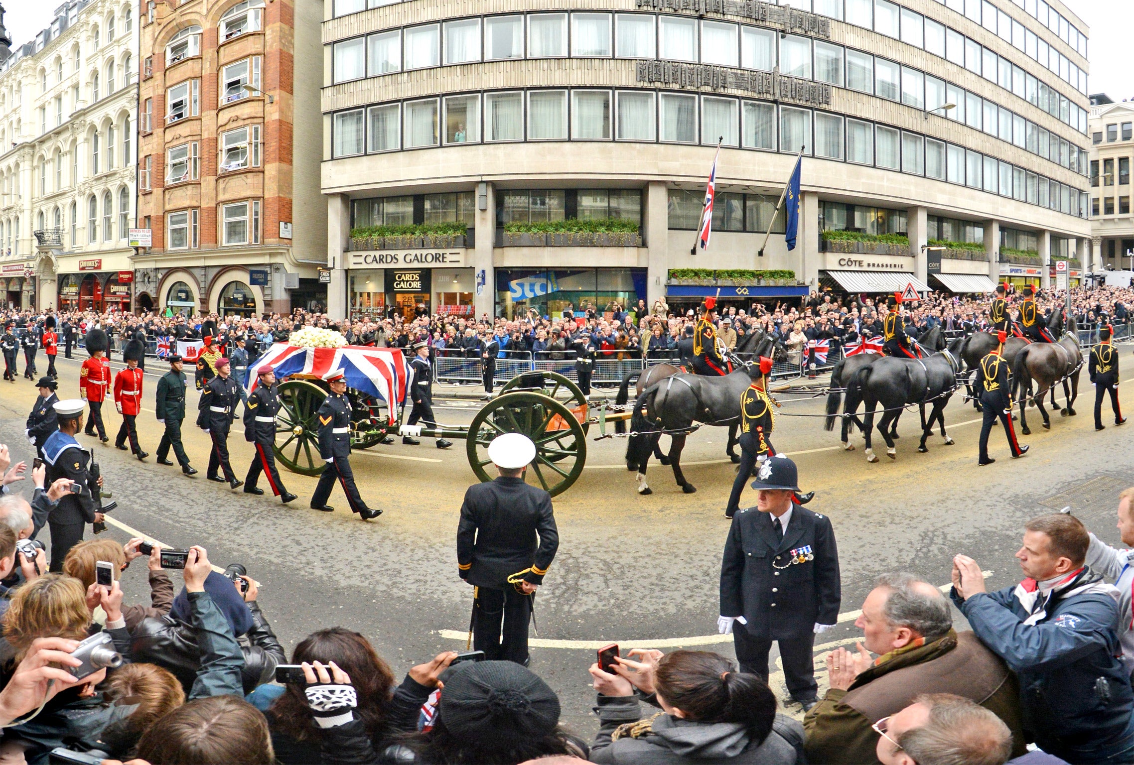 The coffin of Baroness Thatcher is brought up Ludgate Hill