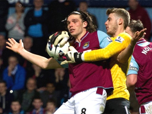 Andy Carroll tangles with Manchester United keeper David De Gea
