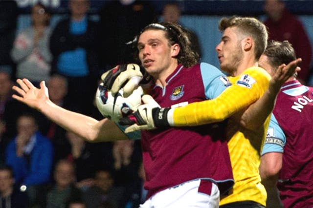 Andy Carroll tangles with Manchester United keeper David De Gea 