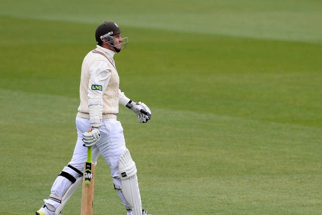 Graeme Smith of Surrey makes his way back to the pavilion having been dismissed for two 