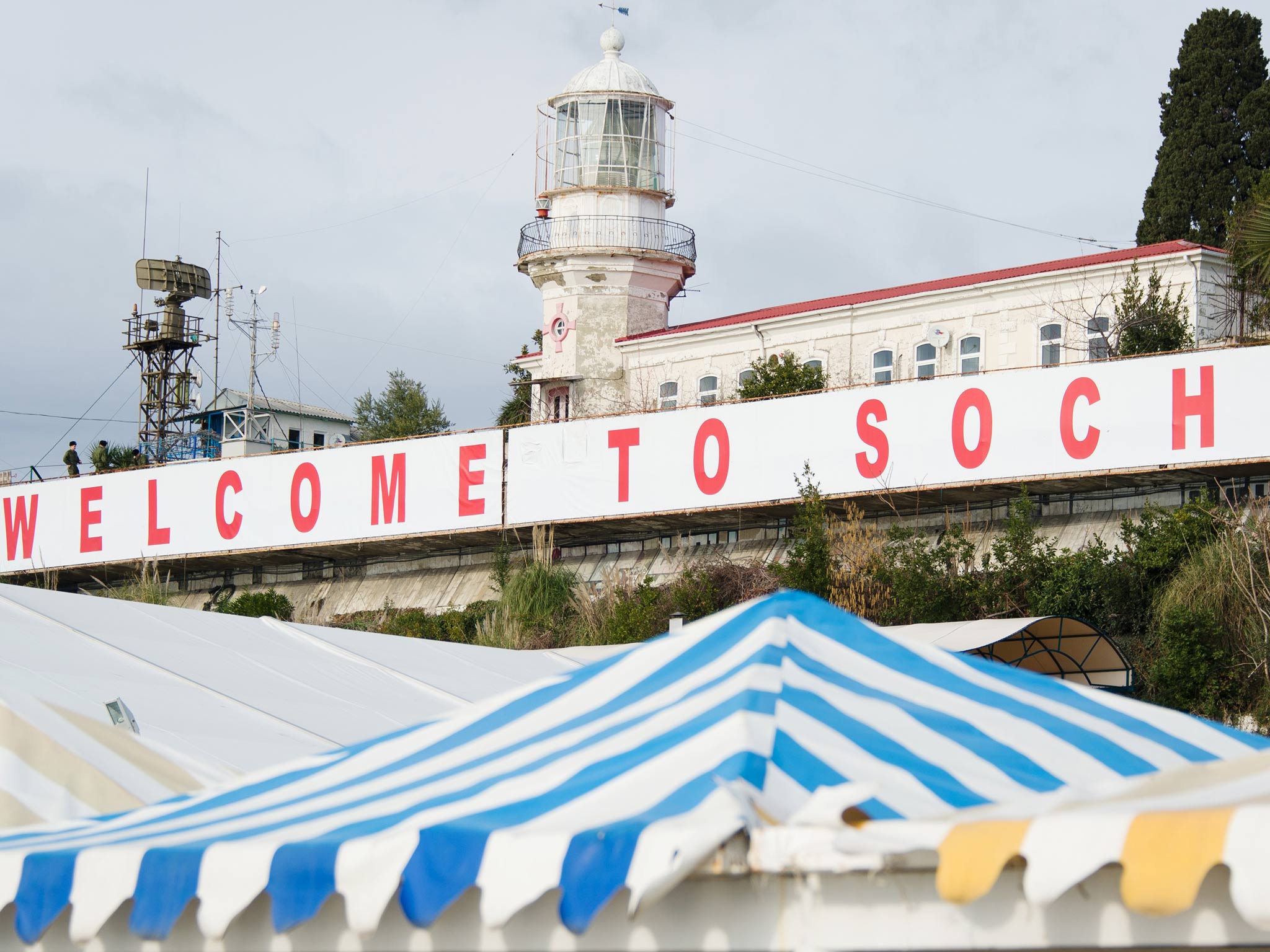 A large 'Welcome to Sochi!' sign hangs above the waterfront area in central Sochi