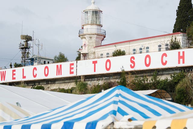 A large 'Welcome to Sochi!' sign hangs above the waterfront area in central Sochi