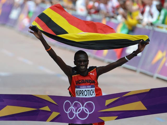Uganda's Stephen Kiprotich waves his national flag as he crosses the finish line at London 2012