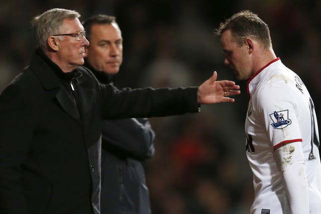 Wayne Rooney walks past manager Sir Alex Ferguson after being substituted against West Ham on Wednesday
