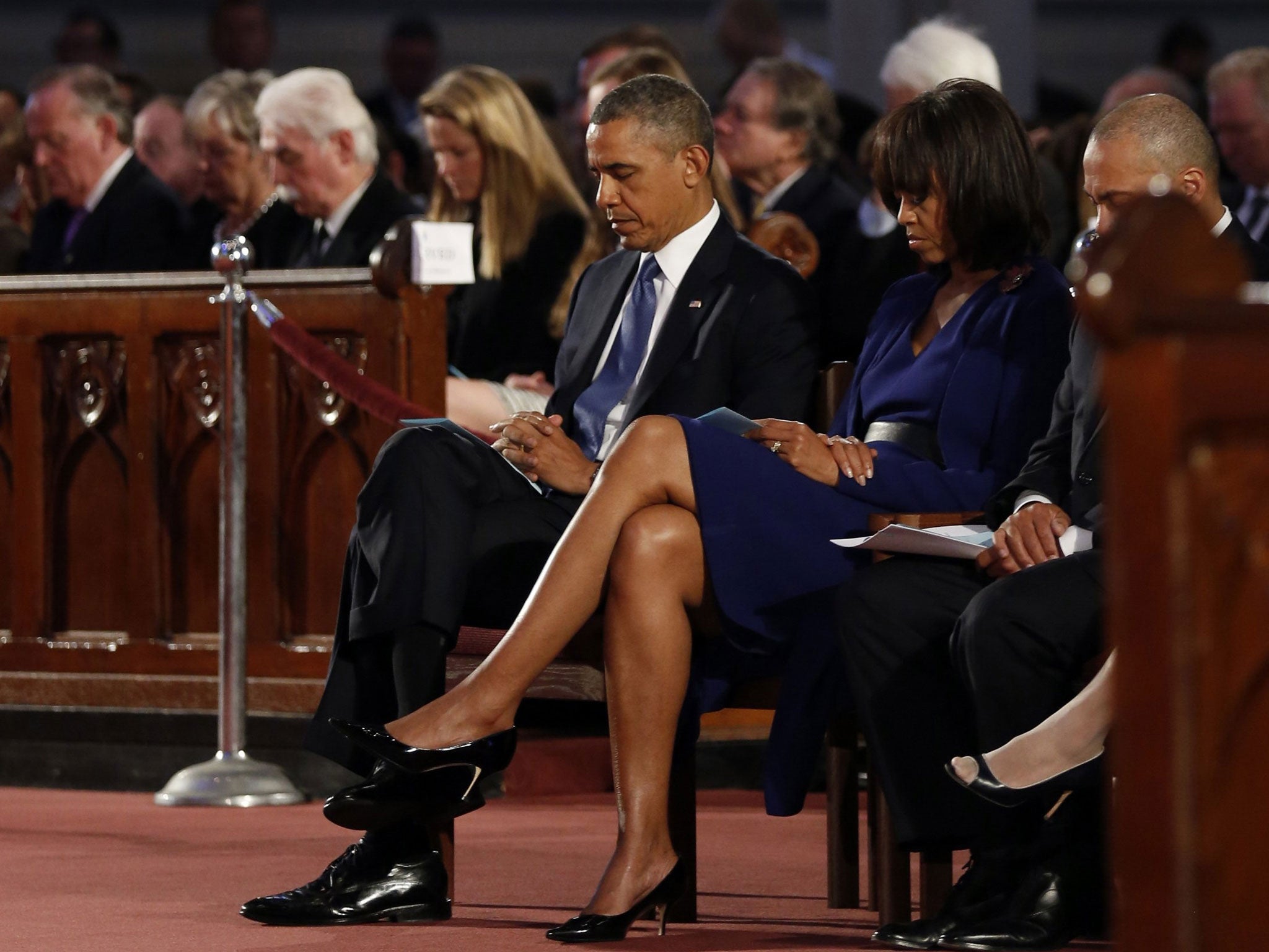 President Barack Obama and first lady Michelle Obama attend an interfaith memorial service at the Cathedral of the Holy Cross for the victims of the Boston Marathon bombing