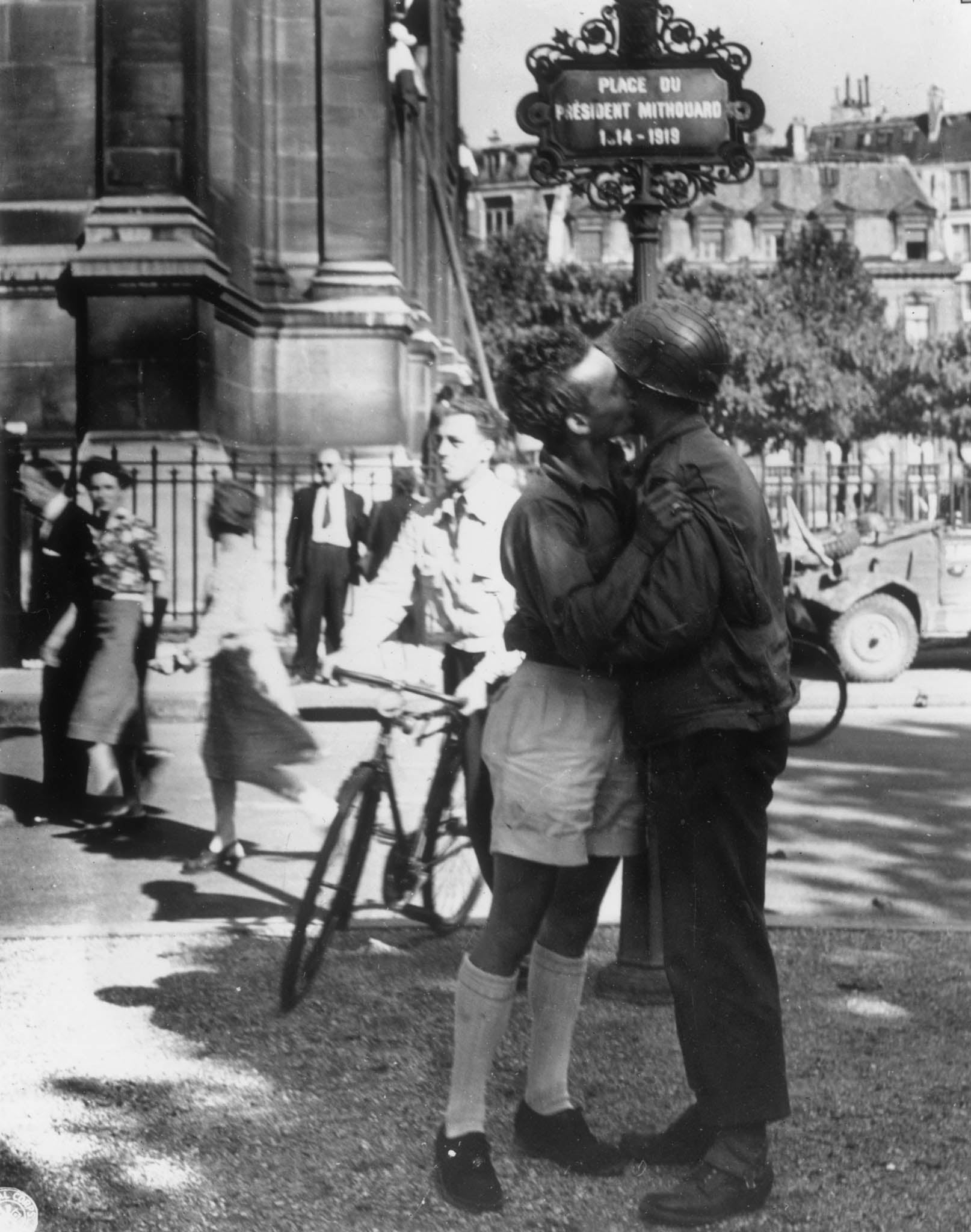 1944: A civilian and a member of the French underground guerrilla band the Marquis exchange a greeting in the street after the Liberation of Paris.