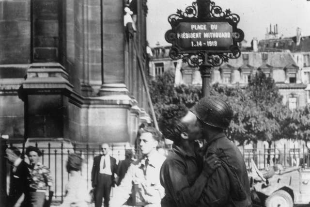 1944: A civilian and a member of the French underground guerrilla band the Marquis exchange a greeting in the street after the Liberation of Paris.