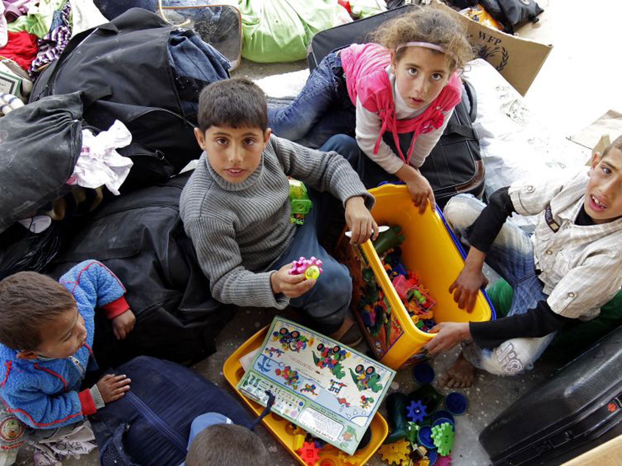 Syrian refugees with toys from the UAE