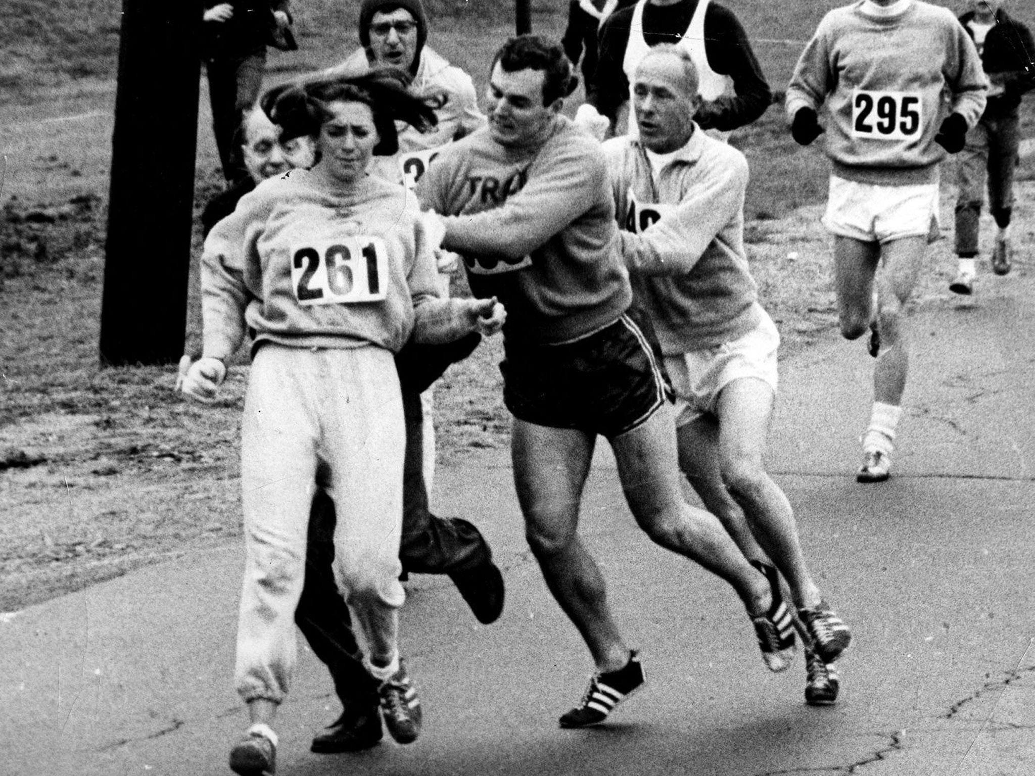 An official (left) tries to remove Kathy Switzer from the Boston Marathon in 1967