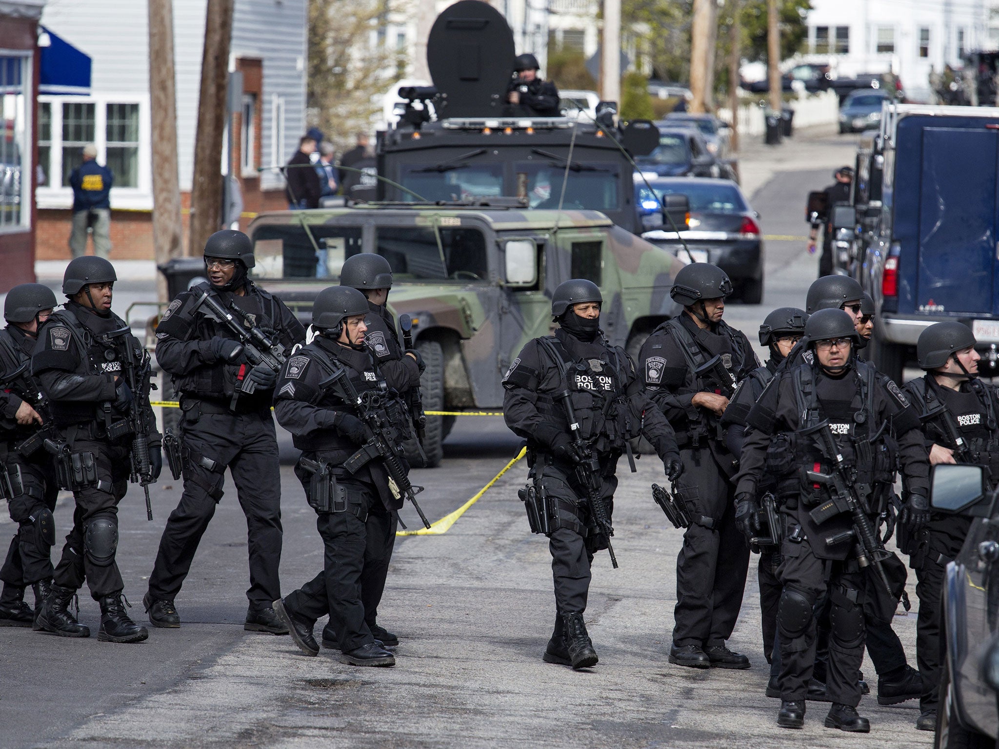 Heavily armed police continue to patrol the neighborhoods of Watertown as they continue a massive search for one of two suspects in the Boston Marathon bombing
