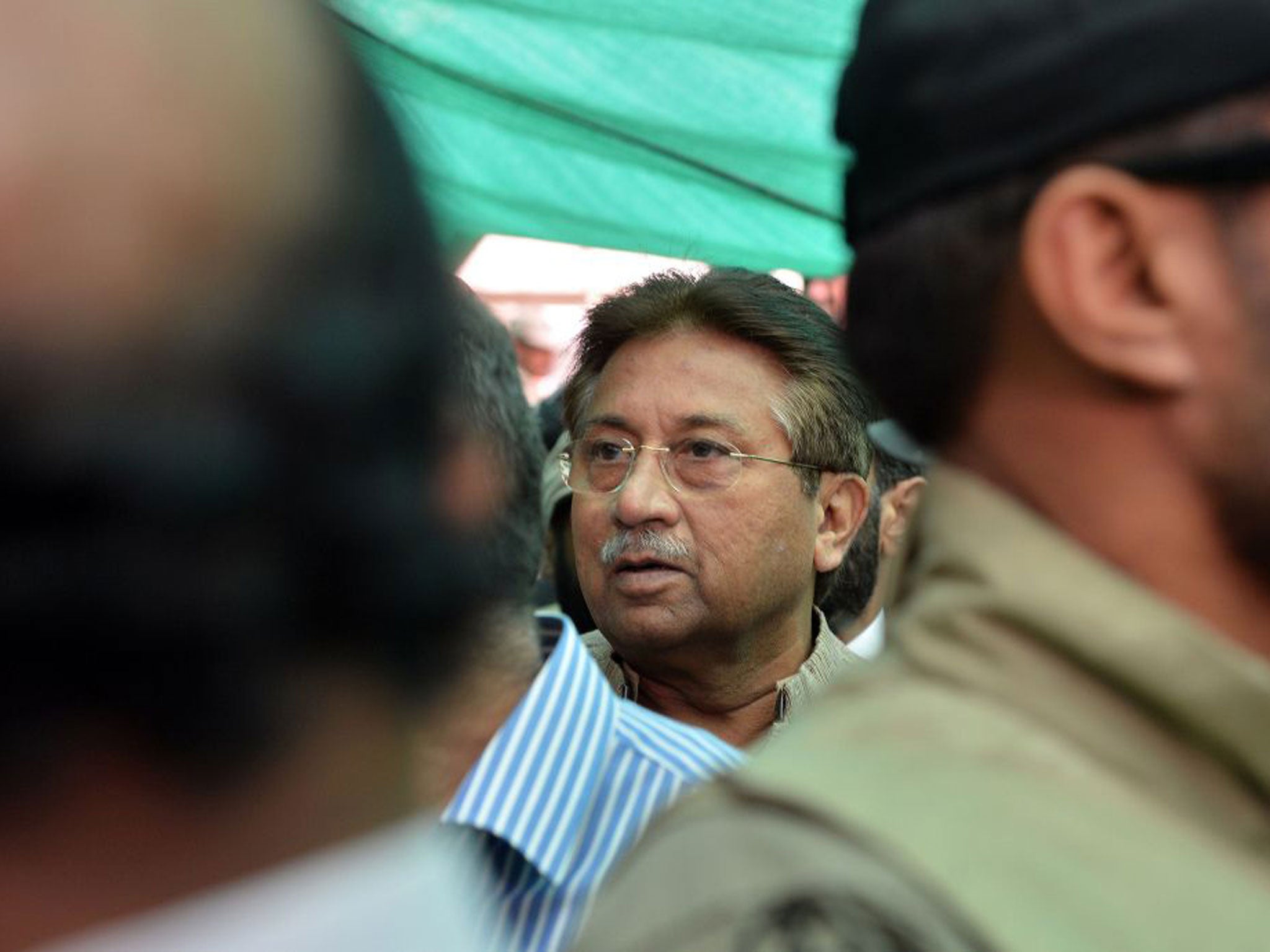 Former Pakistani president Pervez Musharraf is escorted by soldiers as he arrives at an anti-terrorism court in Islamabad