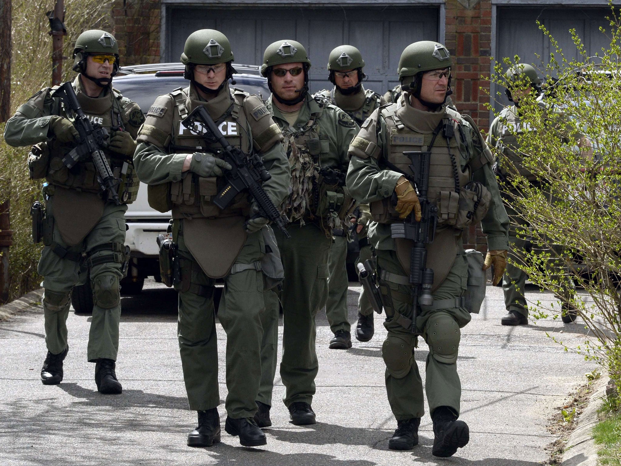 Home watch: A police Swat team searching Watertown, Boston, on Friday