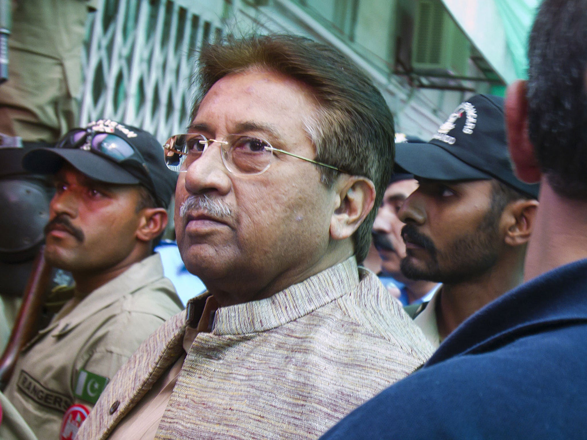 Marked man: Pervez Musharraf arrives at court in Islamabad yesterday