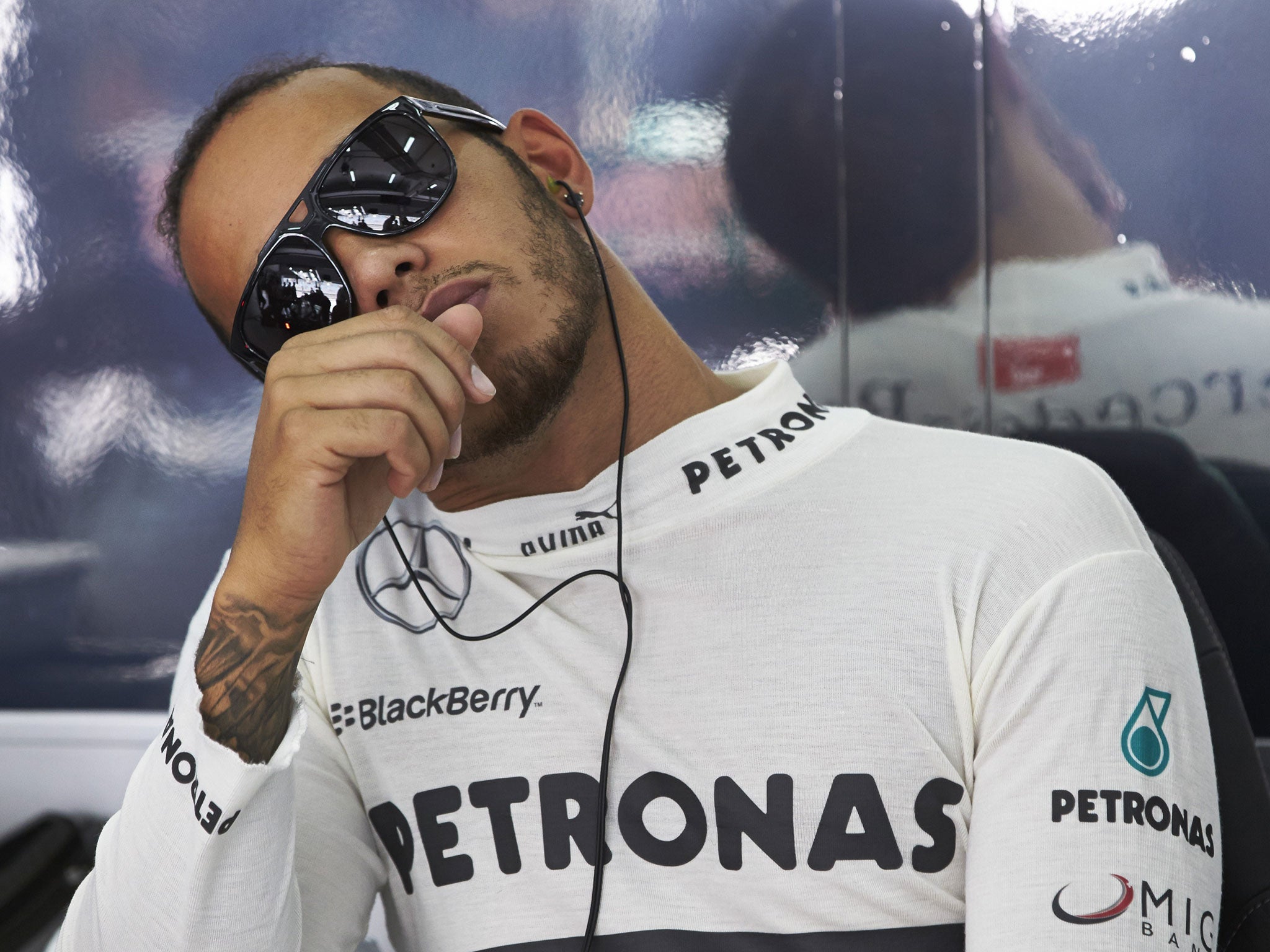 In the shade: Lewis Hamilton tunes out as political issues once again dominate the build-up to the Bahrain Grand Prix