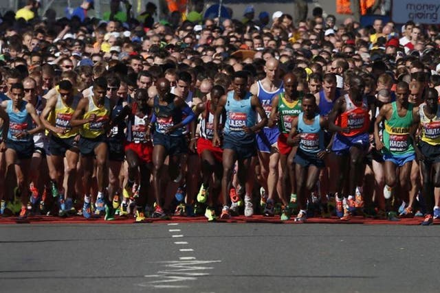 Competitors cross the start line at the beginning of the London Marathon in Greenwich