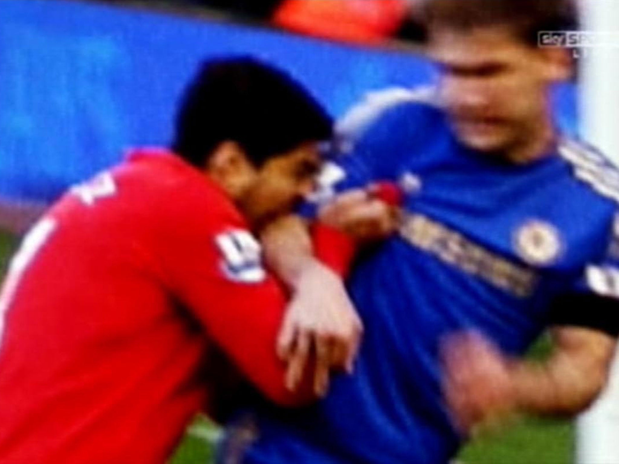 A screen grab of Luis Suarez biting Chelsea defender Branislav Ivanovic